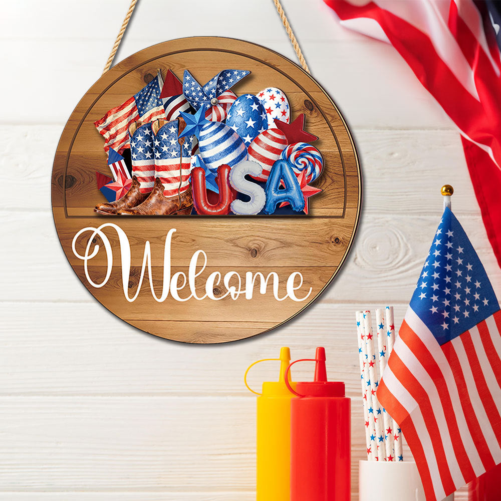 Interchangeable welcome wood sign with USA patriotic cutout beside American flag, 4th of July decor