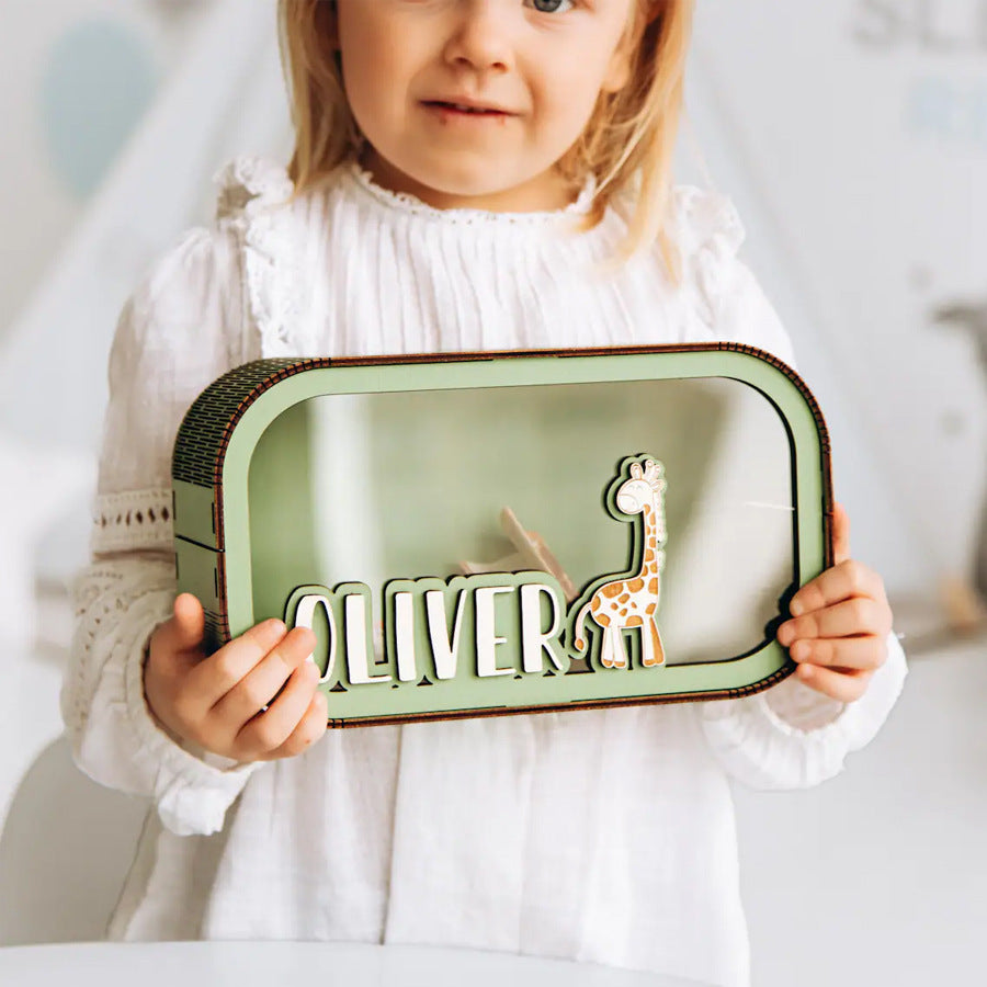 Little girl holding personalized wooden piggy bank, custom name transparent coin savings box