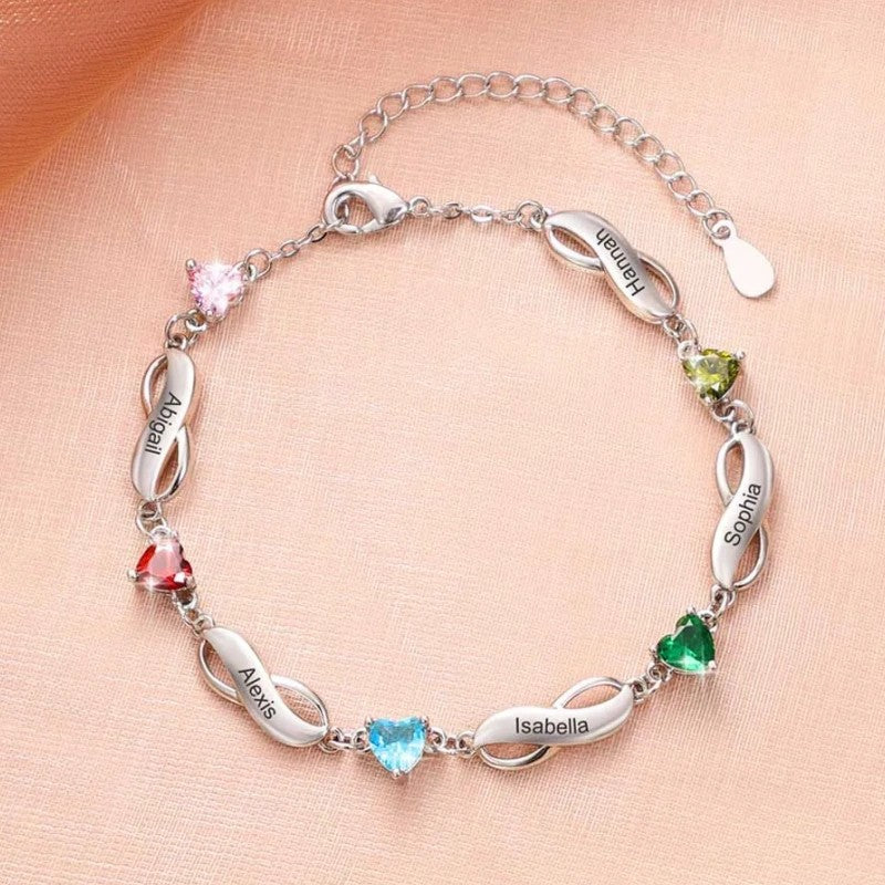 Close-up shot of silver plated brass infinity engraved bracelet with multiple heart cubic zirconia worn on human skin