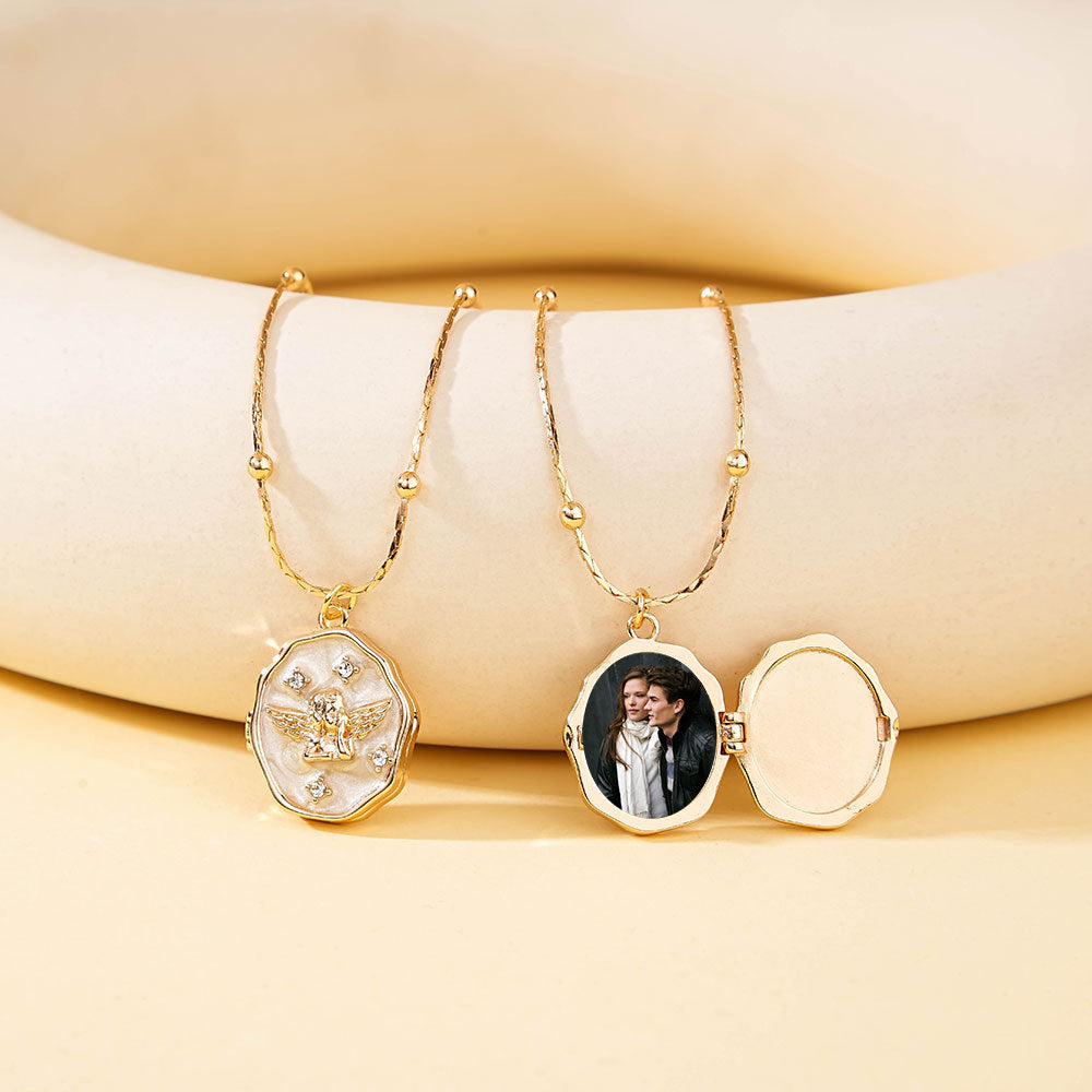 Combination display of closed and opened gold brass angel locket, showing empty inner cavity and photo loaded status