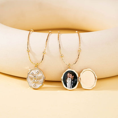 Combination display of closed and opened gold brass angel locket, showing empty inner cavity and photo loaded status