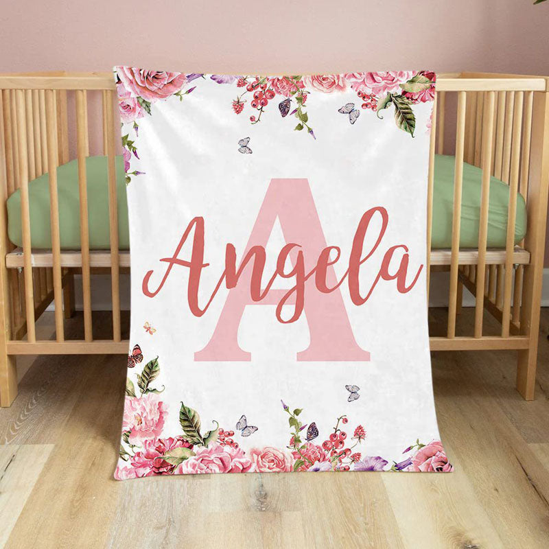 Custom floral name baby blanket laid flat inside wooden crib soft flannel newborn nursery bedding decoration
