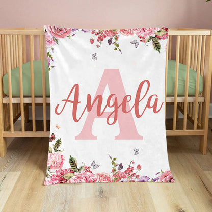 Custom floral name baby blanket laid flat inside wooden crib soft flannel newborn nursery bedding decoration