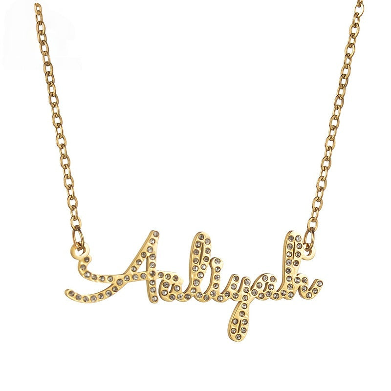 Stainless steel gold cursive zircon name necklace clean studio shot on plain white background