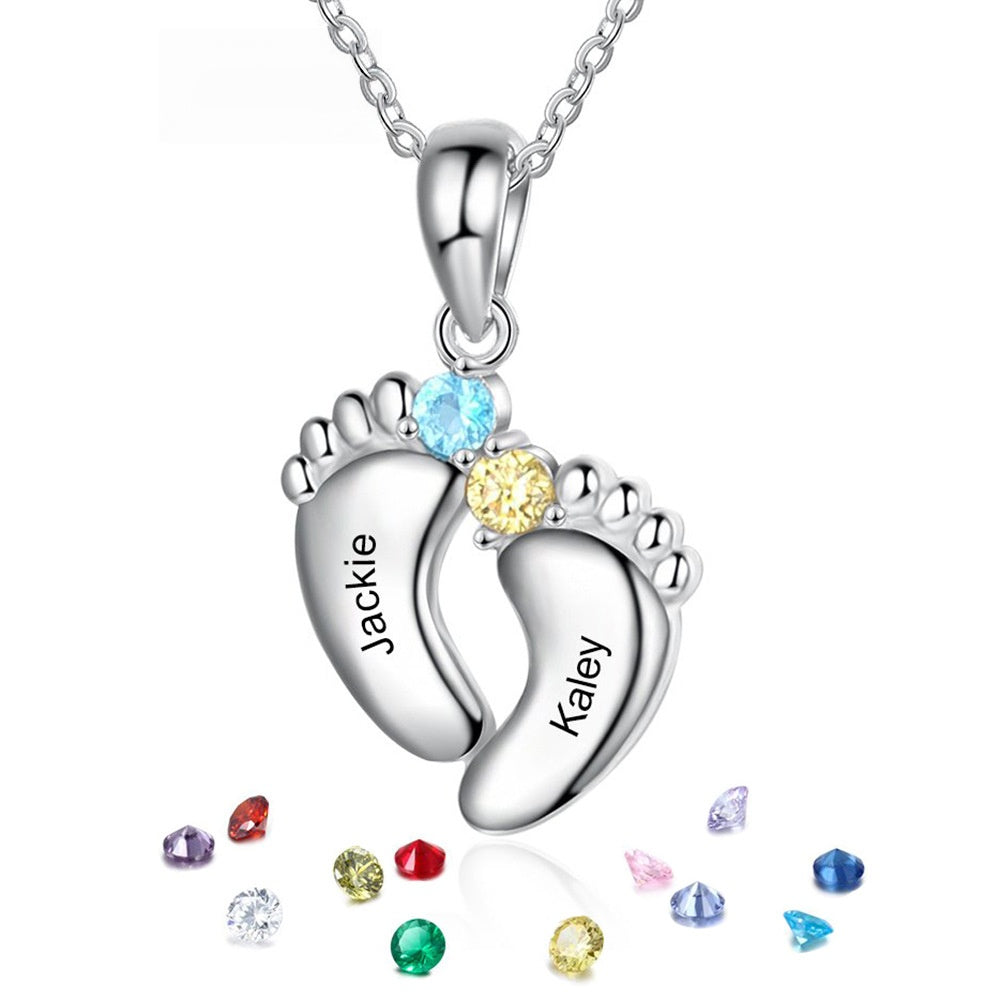Silver brass double footprint pendant engraved with custom names, embedded with two-tone cubic zirconia and scattered birthstone particles