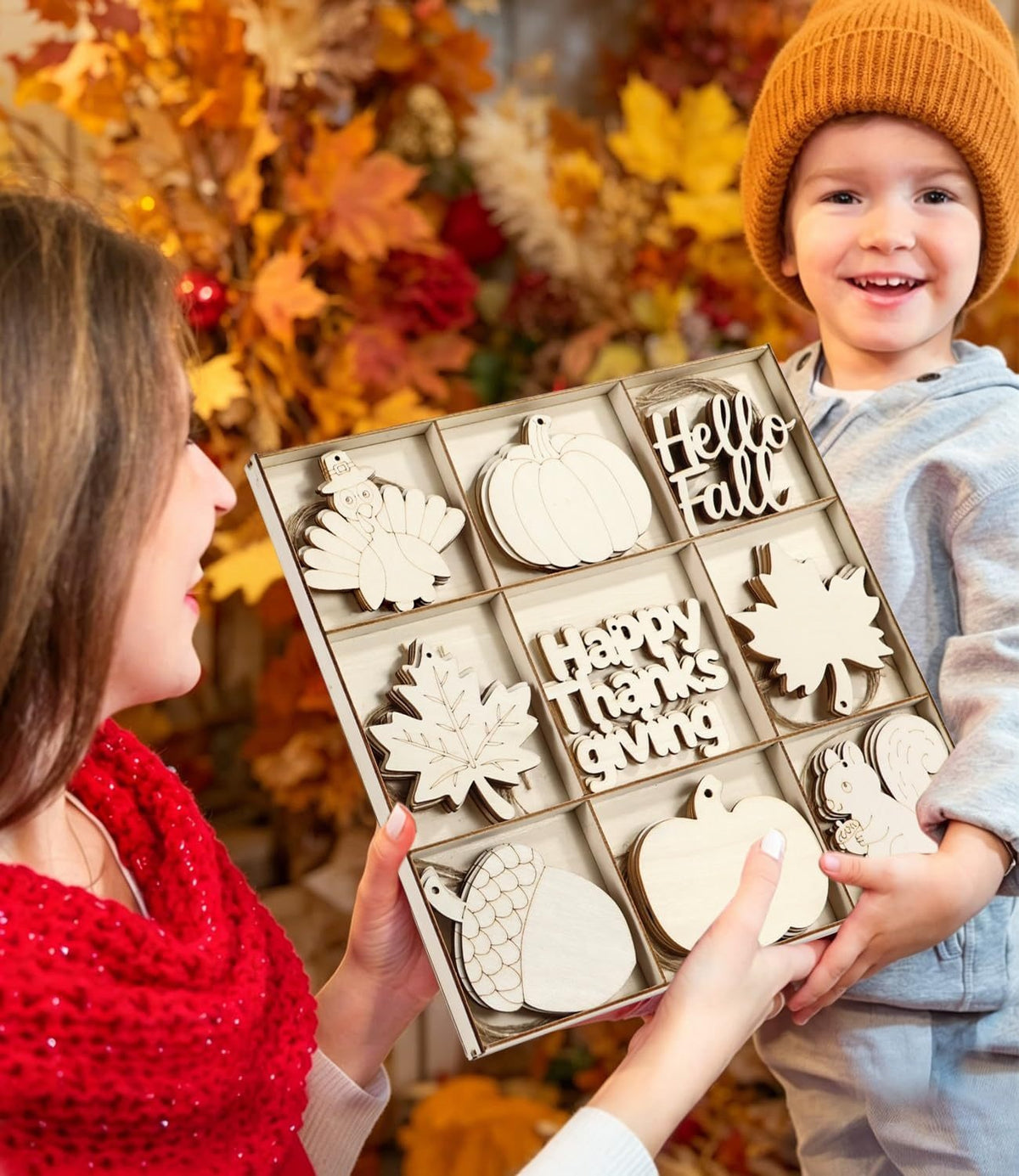 Family DIY craft activity, painting blank fall wooden cutouts to make custom hanging Thanksgiving ornaments