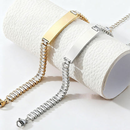 Gold and silver stainless steel zircon engraved bracelets displayed curled on white fabric scroll