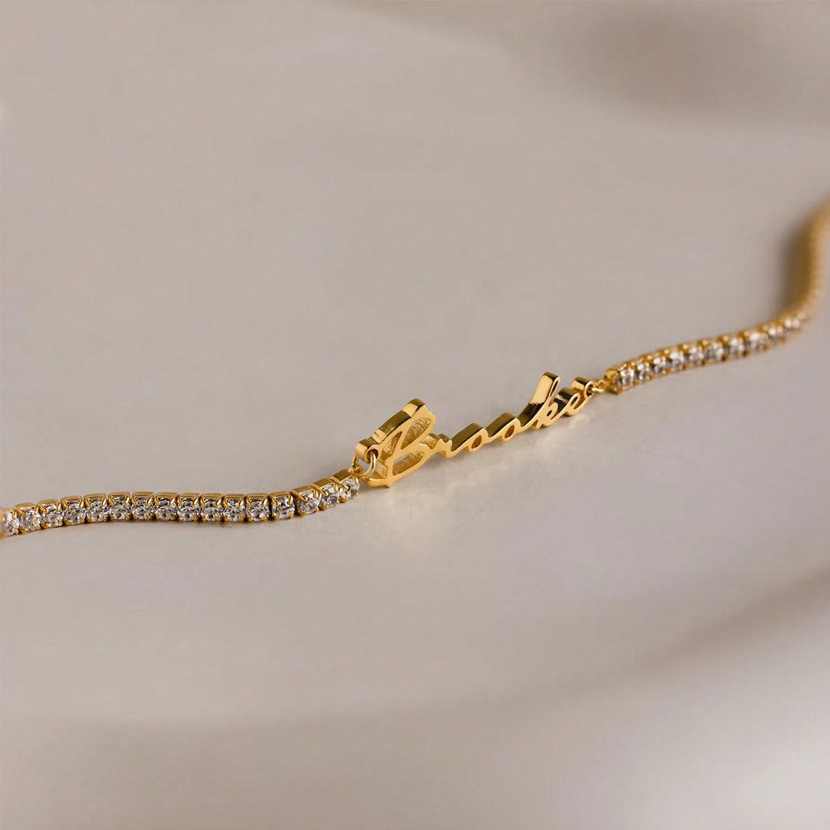 gold stainless steel custom name zircon tennis bracelet with extender chain closeup