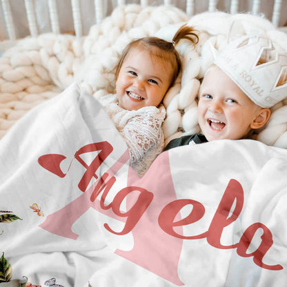 Two kids cuddling under personalized floral name baby blanket cozy soft fleece throw blanket for daily home use