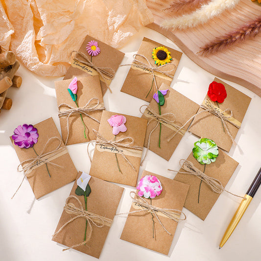 Assorted mini kraft blank note cards set with artificial flowers, twine and seal stickers, rustic gift message stationery