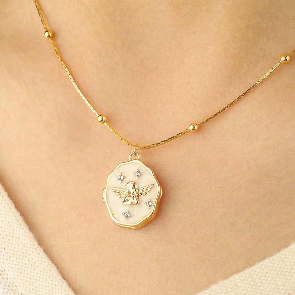 Simple wearing effect of gold brass angel enamel photo locket on female neck with plain background