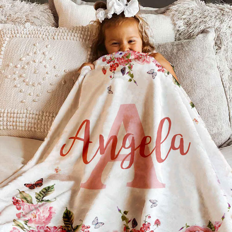 Newborn infant wrapped in personalized floral monogram custom name blanket soft flannel swaddle daily use memory keepsake