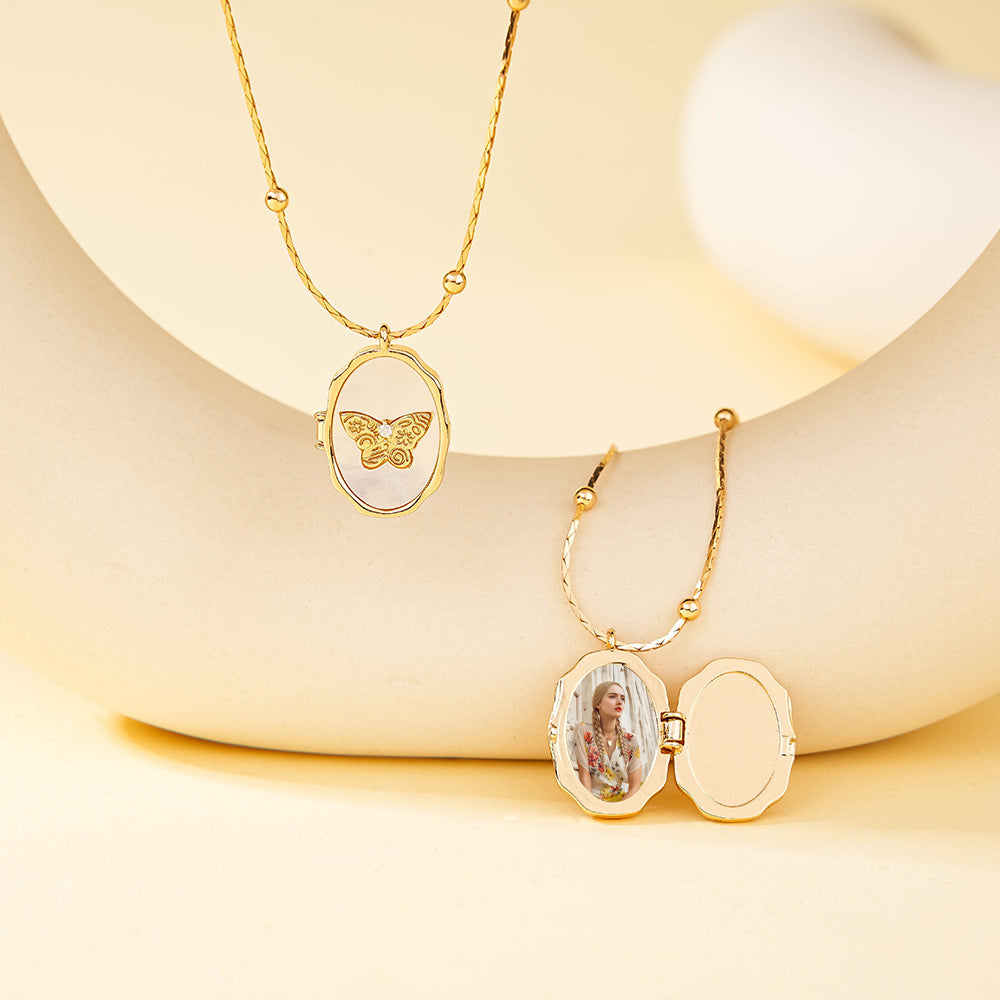 Brass frame shell butterfly locket with open cover, showing internal photo storage space for custom pictures