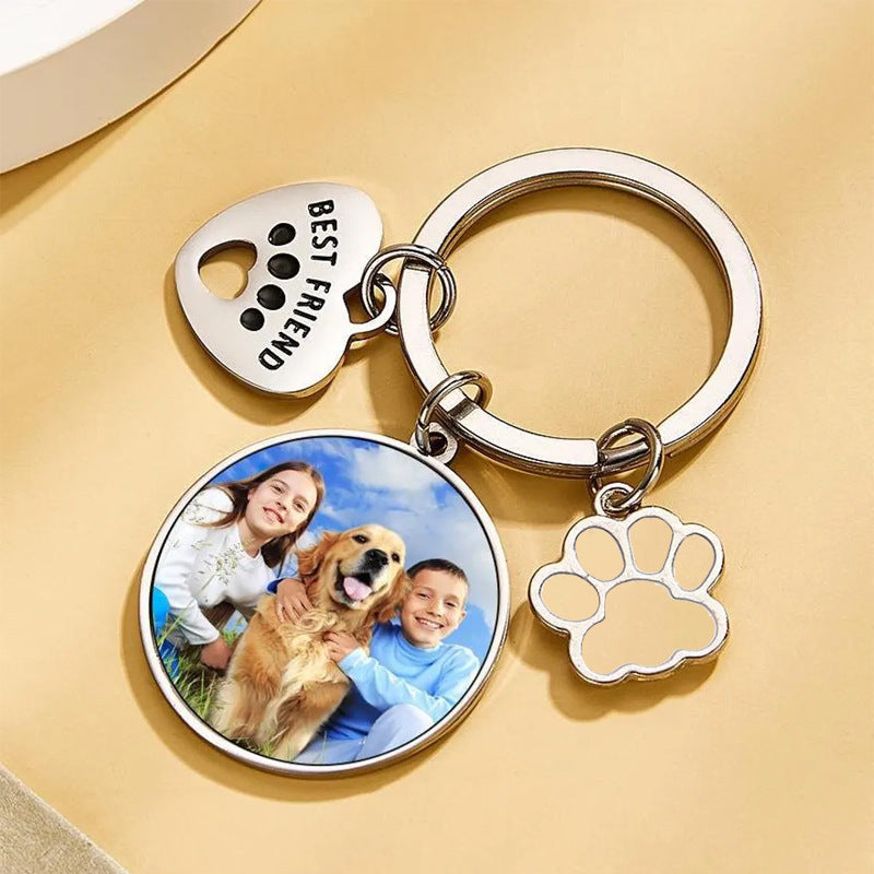 Flat lay custom dog photo keychain, silver metal paw and heart charm personalized pet memorial keyring