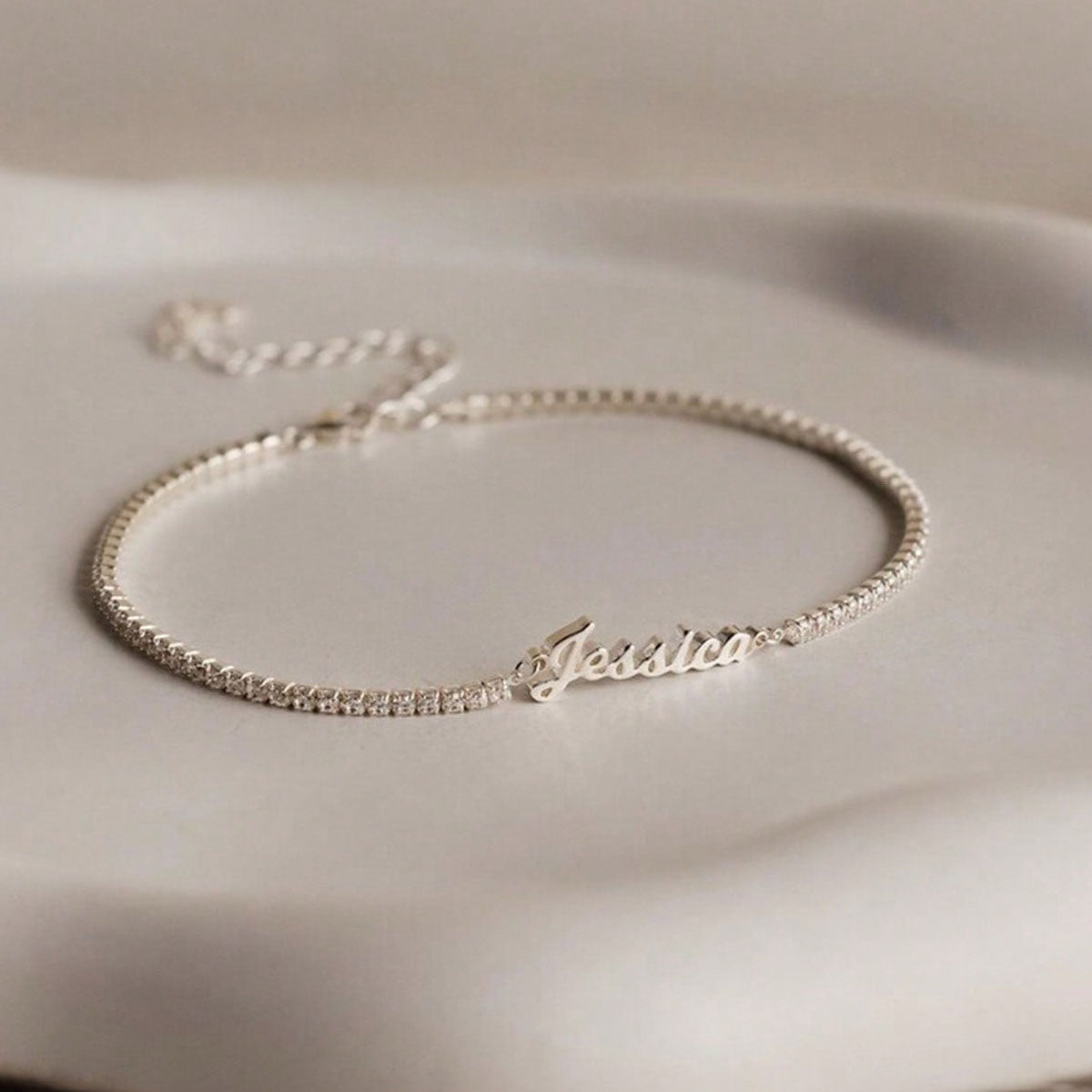Silver personalized cursive name tennis bracelet flat lay