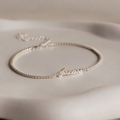 Silver personalized cursive name tennis bracelet flat lay