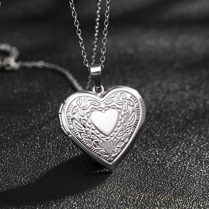 Minimal silver engraved heart photo locket necklace single pendant close-up, sentimental memory jewelry