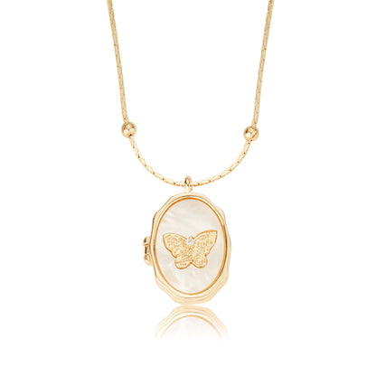 Single oval open photo locket crafted from gold plated brass with natural shell butterfly inlay on plain white backdrop