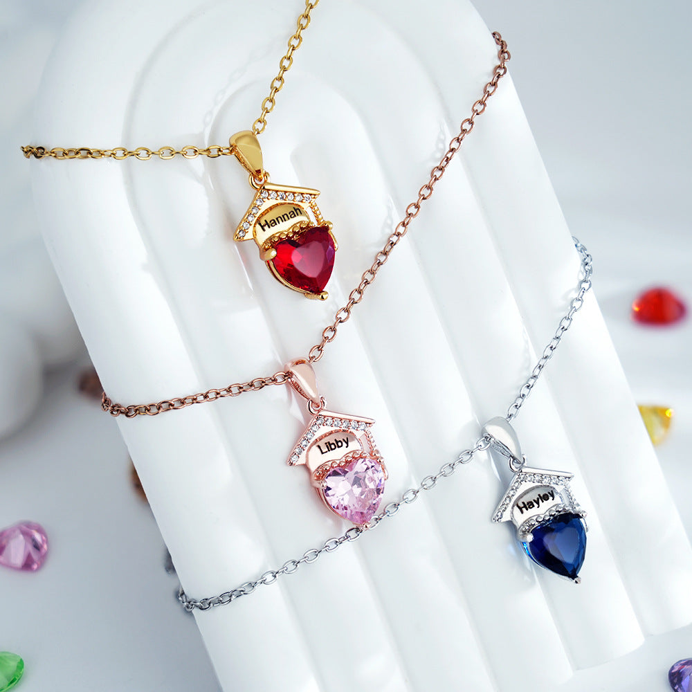 Gold silver rose gold brass graduation necklaces laid on white scroll with different colored heart cubic zirconia