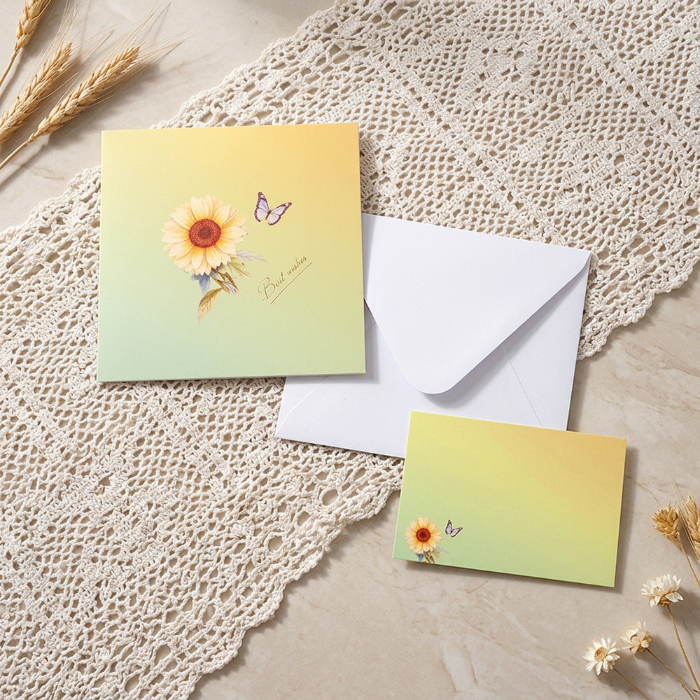 Floral pop up card set with white envelope and blank message note flat lay
